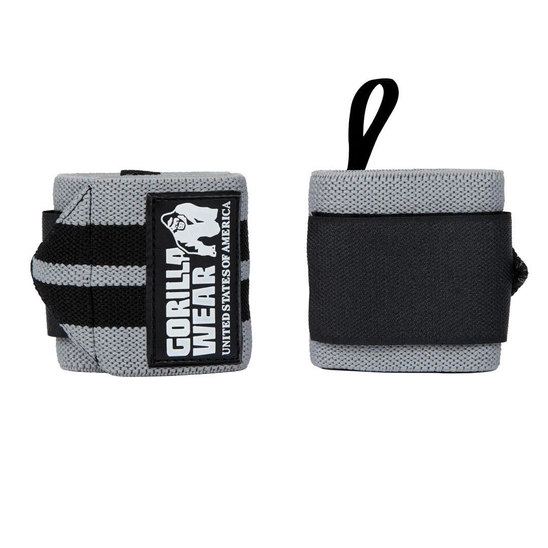 Grå og svarte Gorilla Wear Wrist Wraps Pro med fremtredende logo for støtte under tunge løft.
