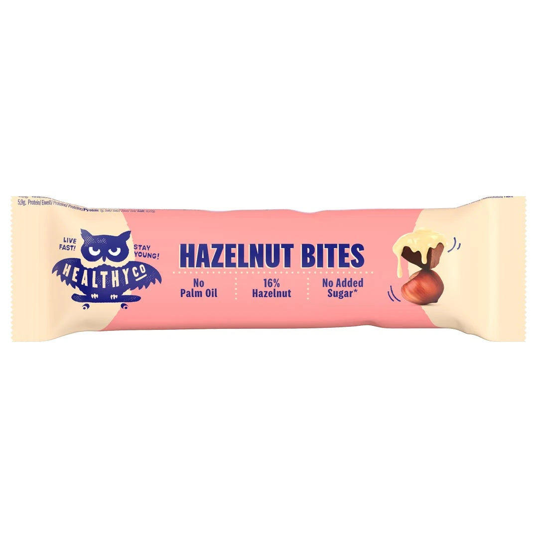 Healthyco Hazelnut Bites 21 g sjokoladebit i en rosa og lysbeige emballasje med mørkeblå tekst.