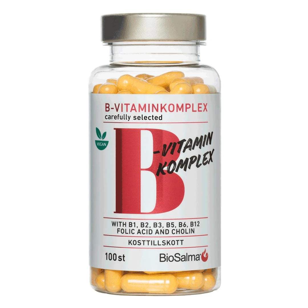 BioSalma B-vitamin Komplex 100 caps i en gjennomsiktig boks med sølvlokk, hvit etikett og gule kapsler.