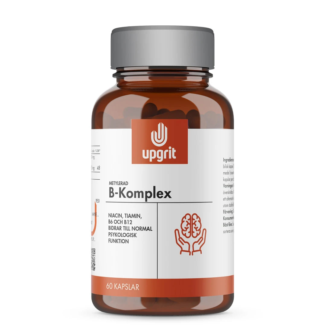 Upgrit B-Komplex 60 kapsler i en mørkebrun boks med sølvlokk og hvit etikett med oransje detaljer.