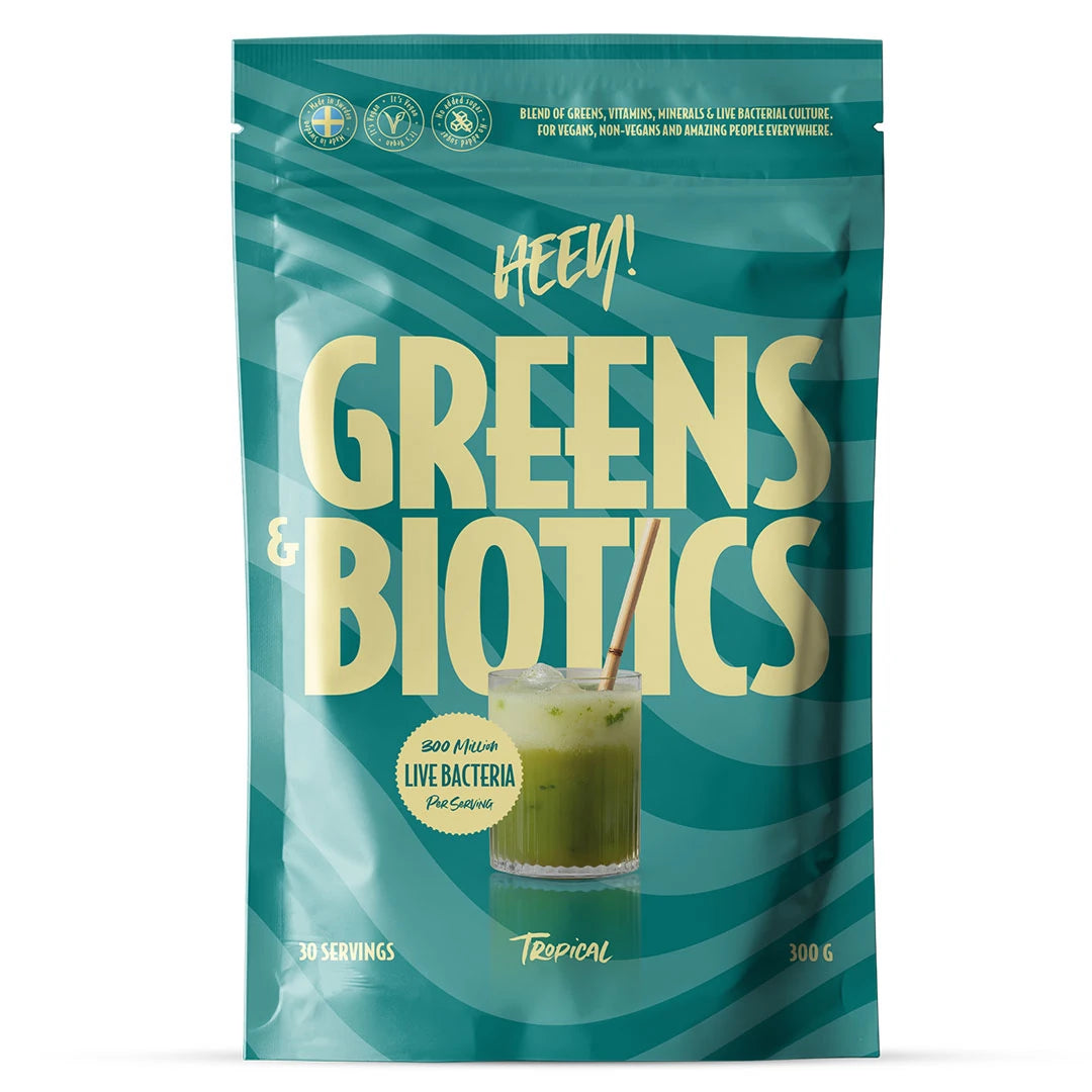 Heey! Greens & Biotics Superfood + Probiotics 300 g i en blågrønn pose for smaken Tropical.