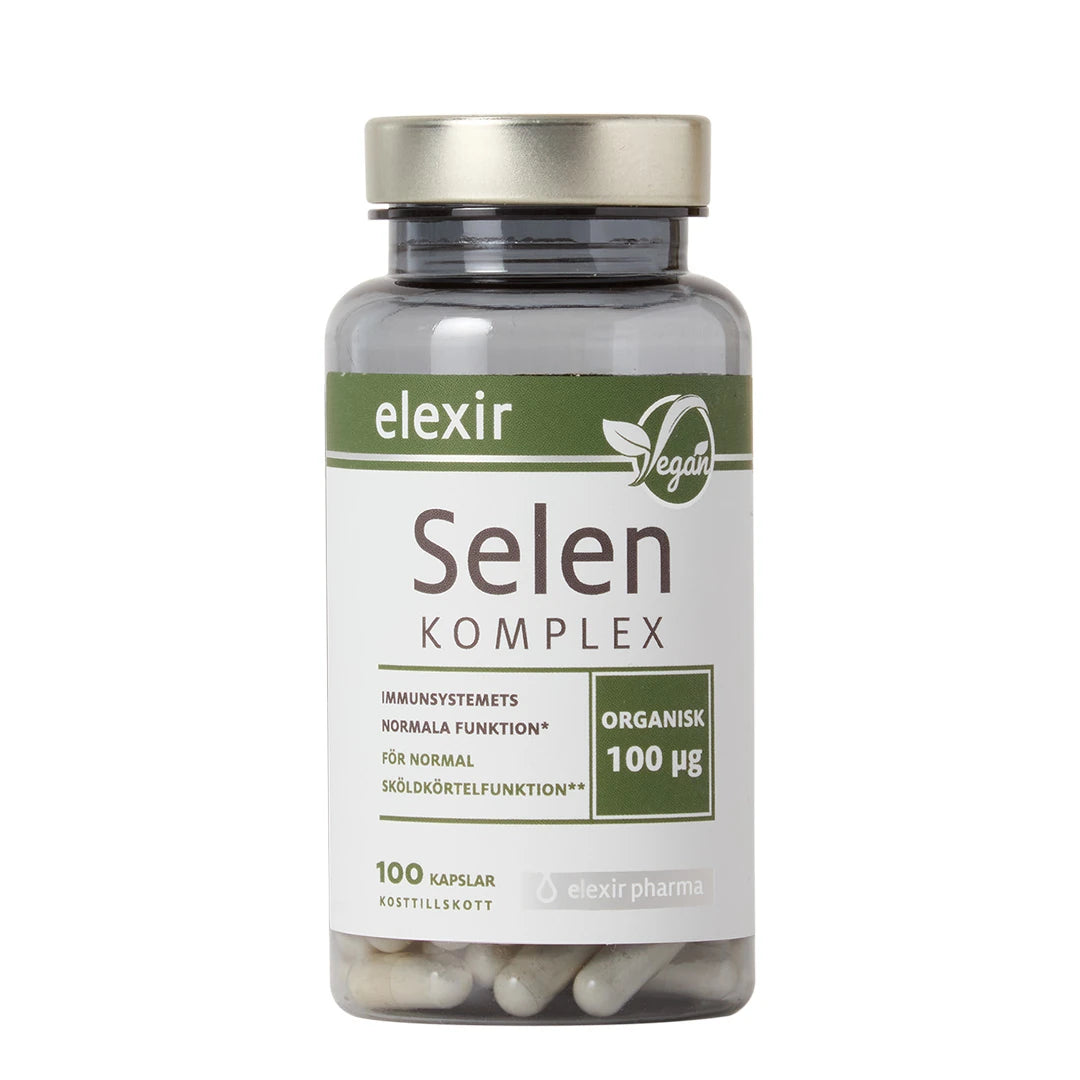 Elexir Pharma Selen Komplex 100 caps i en gjennomsiktig plastboks med sølvlokk og grønnhvit etikett.