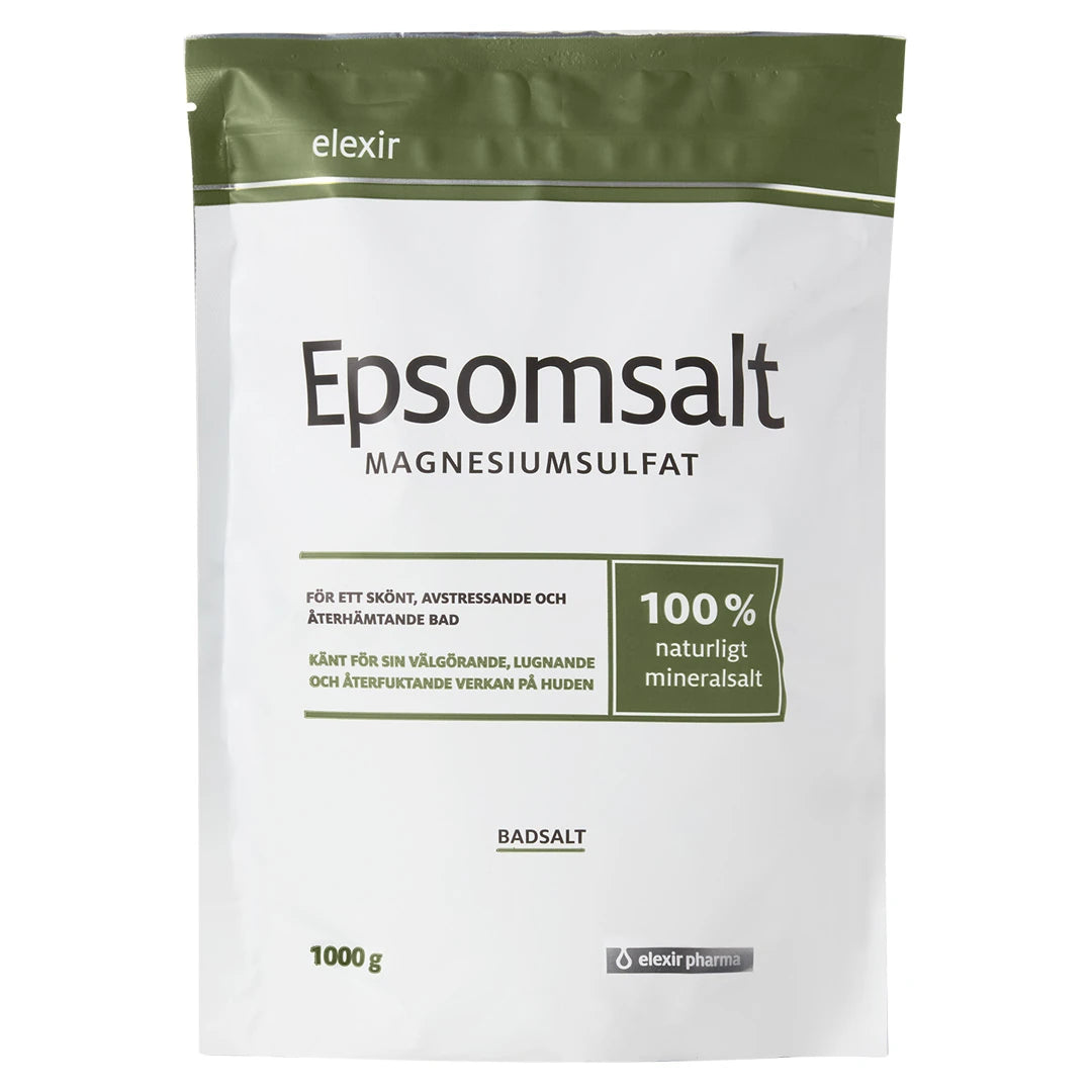 Elexir Pharma Epsomsalt 1kg i en hvit pose med olivengrønne detaljer, et naturlig mineralsalt for avslappende bad.