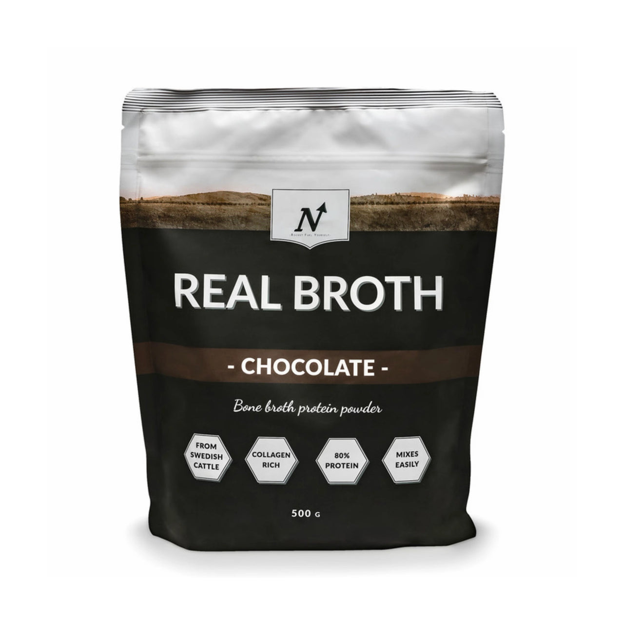 Nyttoteket Real Broth 500 g benbuljongpulver i en svart og hvit pose med brune detaljer for smaken Chocolate.