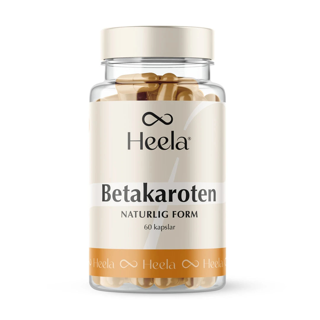 Heela Betakaroten 25 mg 60 caps i en transparent boks med beige etikett og hvite detaljer, fylt med gullfargede kapsler.