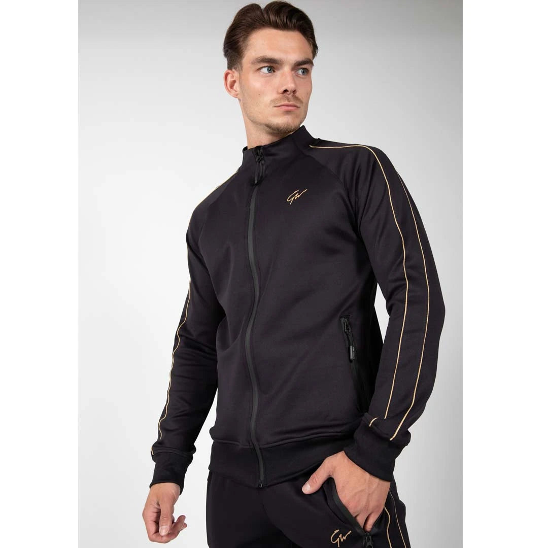 Gorilla Wear Wenden Track Jacket Black/Gold, en svart treningsjakke med gulldetaljer båret av en mannlig modell., bilde 7 av 8