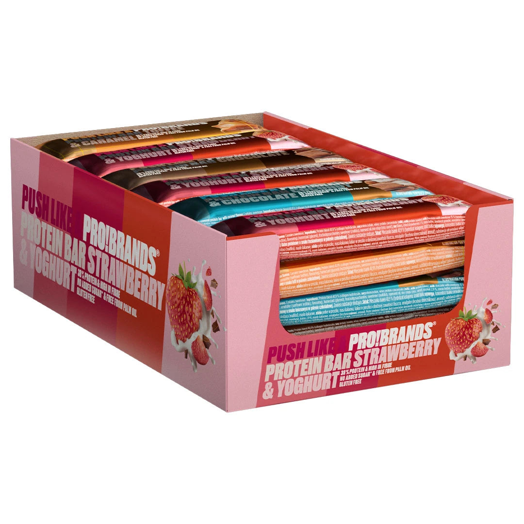 24 x Pro Brands Proteinbar 45 g Mixpack i en rosa displayeske fylt med proteinbarer i ulike smaker.
