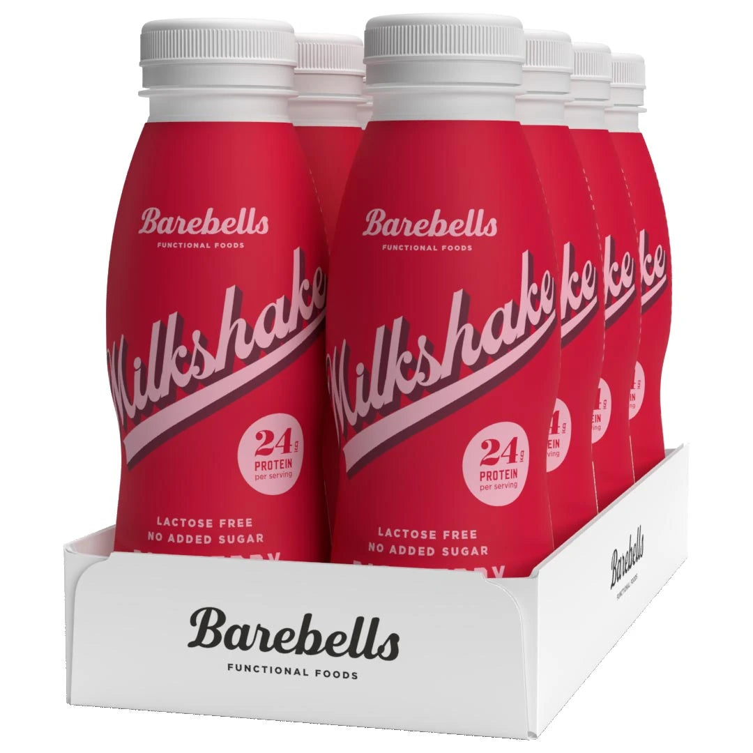 8 x Barebells Milkshake 330 ml Raspberry i et hvitt brett med åtte røde flasker for smaken bringebær.
