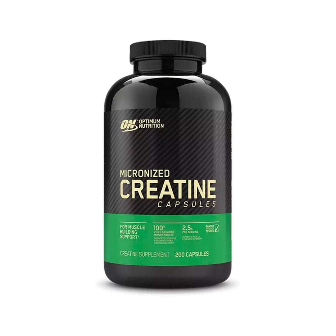 Optimum Nutrition Creatine Capsules 200 caps i en svart boks med grønn etikett.